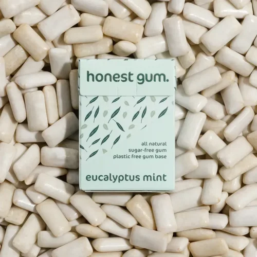 Honest Gum Eucalyptus Mint Plasitic Free Natural 17g laying on top of a pile of gum