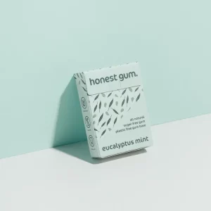 Honest Gum Eucalyptus Mint Plasitic Free Natural 17g leaning against a wall with the front of the packaging showing