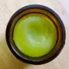 Looking into a container of Nature Body Kawakawa Balm 30g with the lid off.