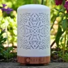 Zurma Diffuser Mandala Glow on a table with greenery in the background