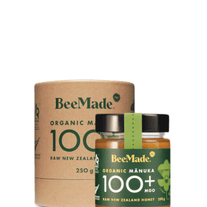 A jar of Beemade Manuka Honey 100+ 250g in front of its packaging