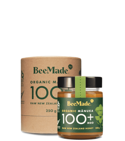 A jar of Beemade Manuka Honey 100+ 250g in front of its packaging
