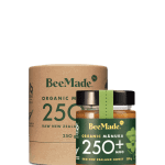 A jar of Beemade Manuka Honey 250+ 250g in front of its packaging
