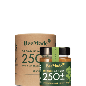 A jar of Beemade Manuka Honey 250+ 250g in front of its packaging