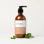 HerbFarm Body Lotion Pink Grapefruit Toning 200ml next to sprigs of Gotu Kola