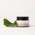 HerbFarm Hand Cream Refining Decolletage 50m next to a Gingko biloba leaf