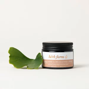 HerbFarm Hand Cream Refining Decolletage 50m next to a Gingko biloba leaf