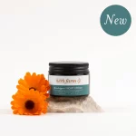 HerbFarm Meno Support Night Cream 50ml on a stone next to Calendula flowers
