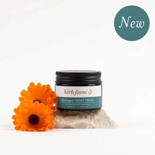 HerbFarm Meno Support Night Cream 50ml on a stone next to Calendula flowers