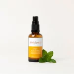 HerbFarm Mood Mist Energise 50ml spray bottle next to a sprig of mint.