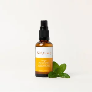 HerbFarm Mood Mist Energise 50ml spray bottle next to a sprig of mint.