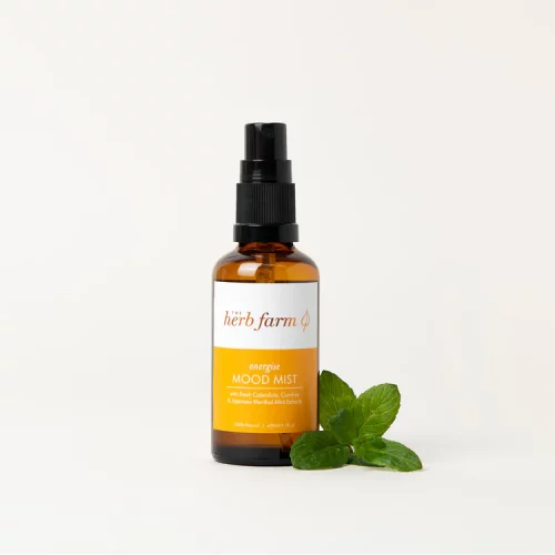 HerbFarm Mood Mist Energise 50ml spray bottle next to a sprig of mint.