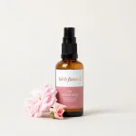 HerbFarm Mood Mist Love 50ml next to a rose flower.