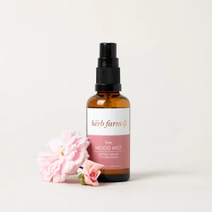HerbFarm Mood Mist Love 50ml next to a rose flower.