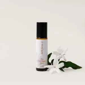HerbFarm Sia Natural Perfume 10ml next to Jasmine flowers.