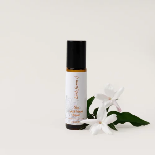 HerbFarm Sia Natural Perfume 10ml next to Jasmine flowers.