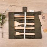 Unrolled Honeywrap Reusable Cutlery Set Green on a wooden table