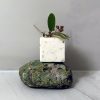 Oku Soap Bar on a green rock