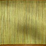 a Voodoo Woven Placemat Dusty Green on a wood table