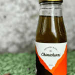 a bottle of DrippingBowl Chimichurri 250ml sitting on grass
