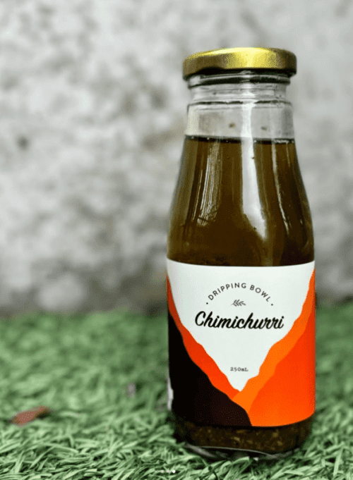 a bottle of DrippingBowl Chimichurri 250ml sitting on grass