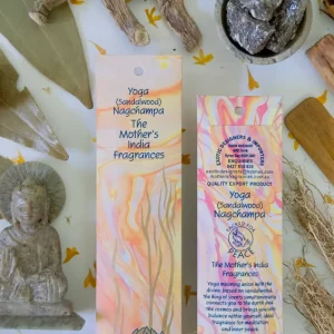 MothersFragrances Yoga Nagchampa on a table with a Budhha statue and incense