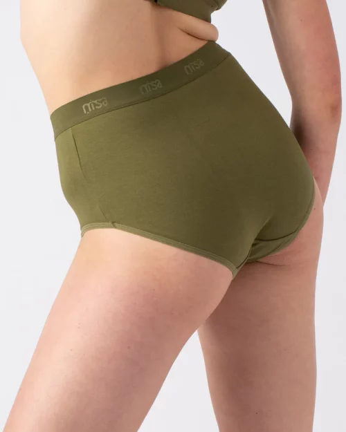 A woman wearing Nisa Sabina Woman Naturals High Cotton Brief Moss coloured