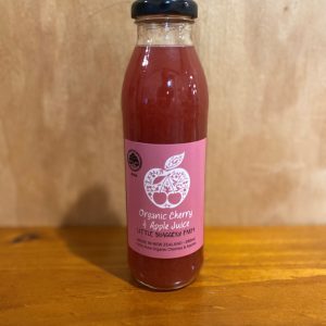 Shaggery Apple Cherry Juice 350ml on a wooden table with a wooden background