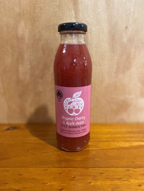 Shaggery Apple Cherry Juice 350ml on a wooden table with a wooden background