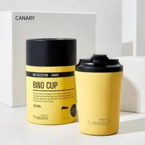 Fressko Bino Coffee Cup Canary 230ml next to its packaing