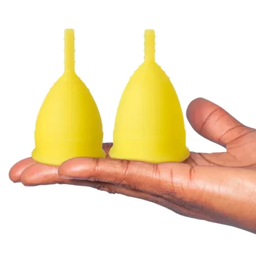 two Lunette Menstrual Cup Yellow #1 upside down on a hand
