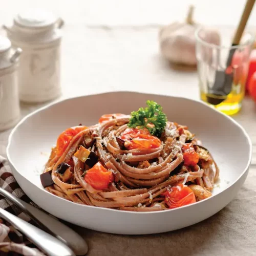 a bowl of tomato pasta made with PerfectEarth Rice Pasta Black 225g