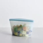 Stasher 6 Cup Bowl - Clear on a table with fruit in it
