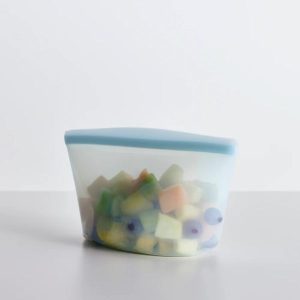 Stasher 6 Cup Bowl - Clear on a table with fruit in it