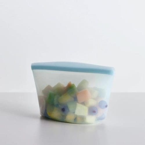 Stasher 6 Cup Bowl - Clear on a table with fruit in it