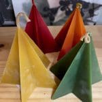 Hohepa Star Pyramid Candle of different colors, red, tan, orange, and green
