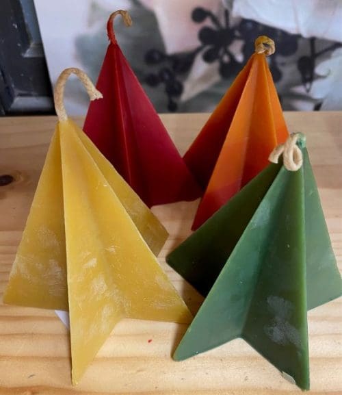 Hohepa Star Pyramid Candle of different colors, red, tan, orange, and green