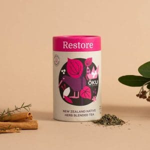 Oku Restore Tea Loose Leaf 30g on a table surrounded by its ingredients