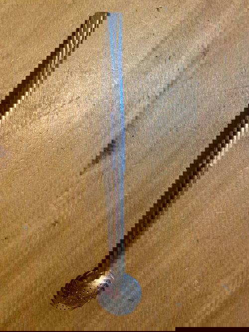 YerbaMate Straw Lollip Filter Stainless Steel on a wooden table